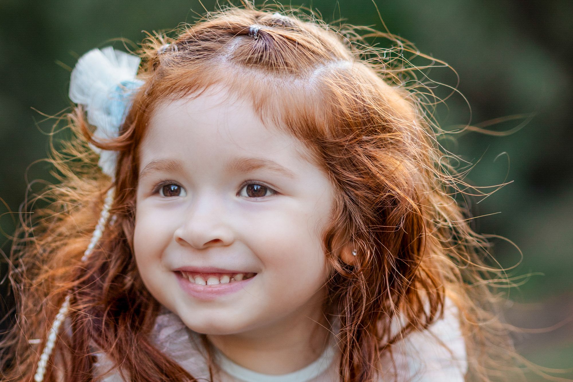 Candid portrait of smiling toddler at park, photographed by Windsor-based children’s photographer Tasha Cannaday.
