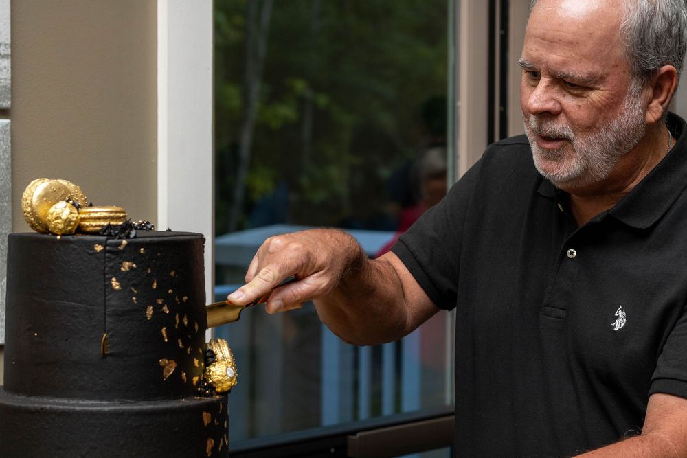 man cutting birthday cake