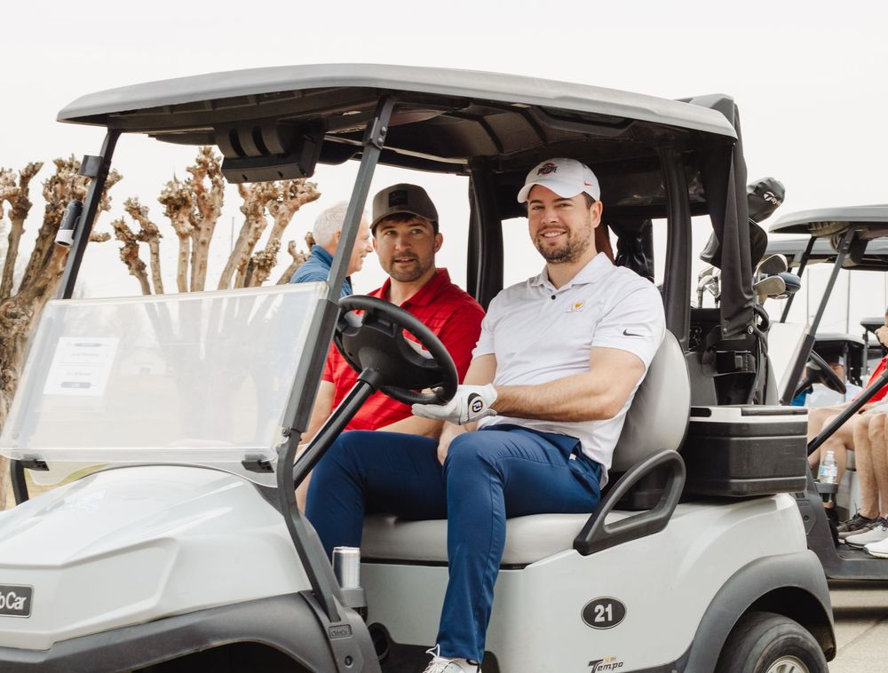 Portrait of Golfers riding in a cart