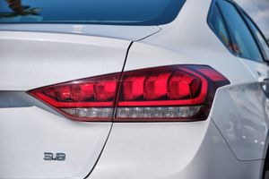 Modern LED taillight design detail of Genesis G80 with 3.8 badge visible.