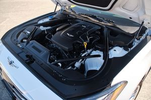 Under the hood view of a Hyundai Genesis engine bay showing the V6 powerplant and components.
