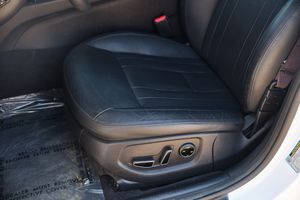 Leather car seat with power adjustment controls mounted on the side panel showing comfort and luxury features.