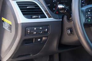 Dashboard control panel showing climate and vehicle settings buttons in a modern car interior.