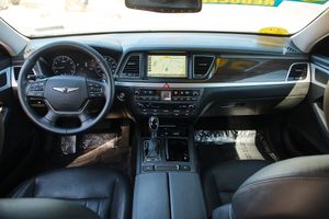 Modern Genesis luxury car dashboard featuring wood trim, leather, and integrated navigation display.