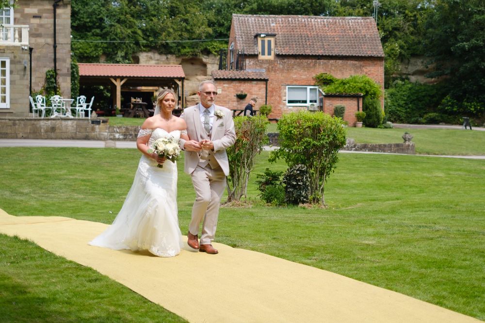 Bride and her father working down the aisle