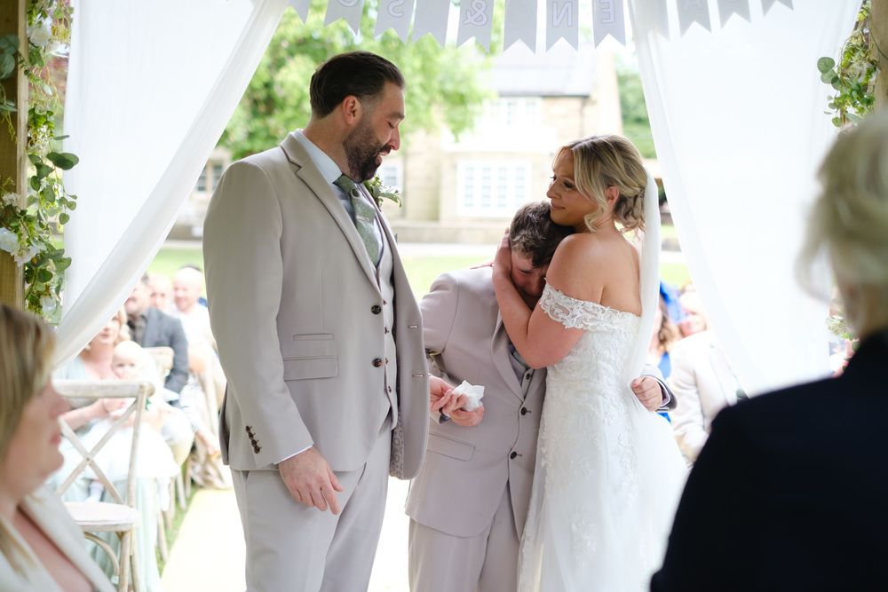 Sophie, Daren and Daren's son at the front of the aisle.