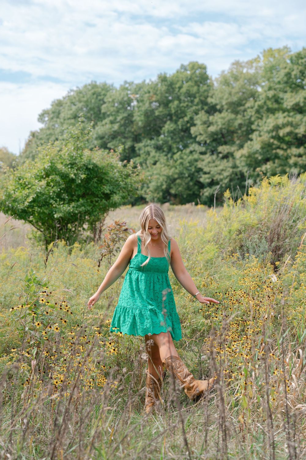 senior having fun kicking her feet in a feild
