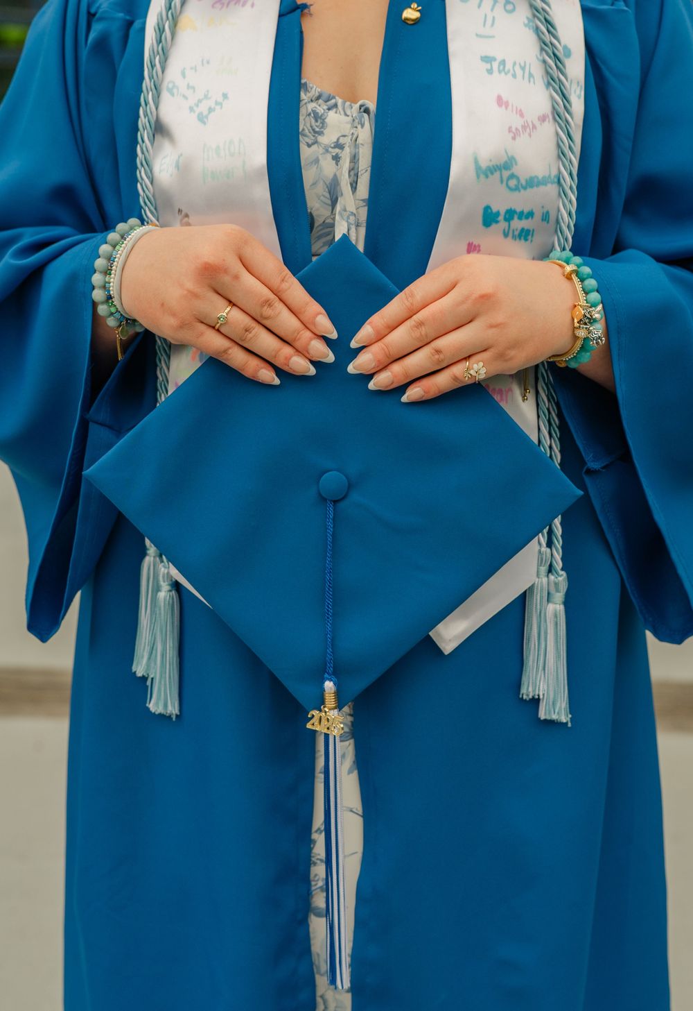 grad holding her cap