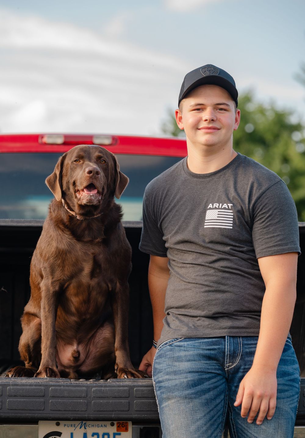 senior with his dog and red truck