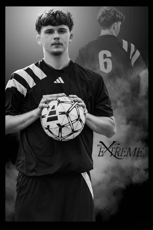 Dramatic black and white soccer portrait with player holding ball and wearing jersey number 6 with Extreme branding.