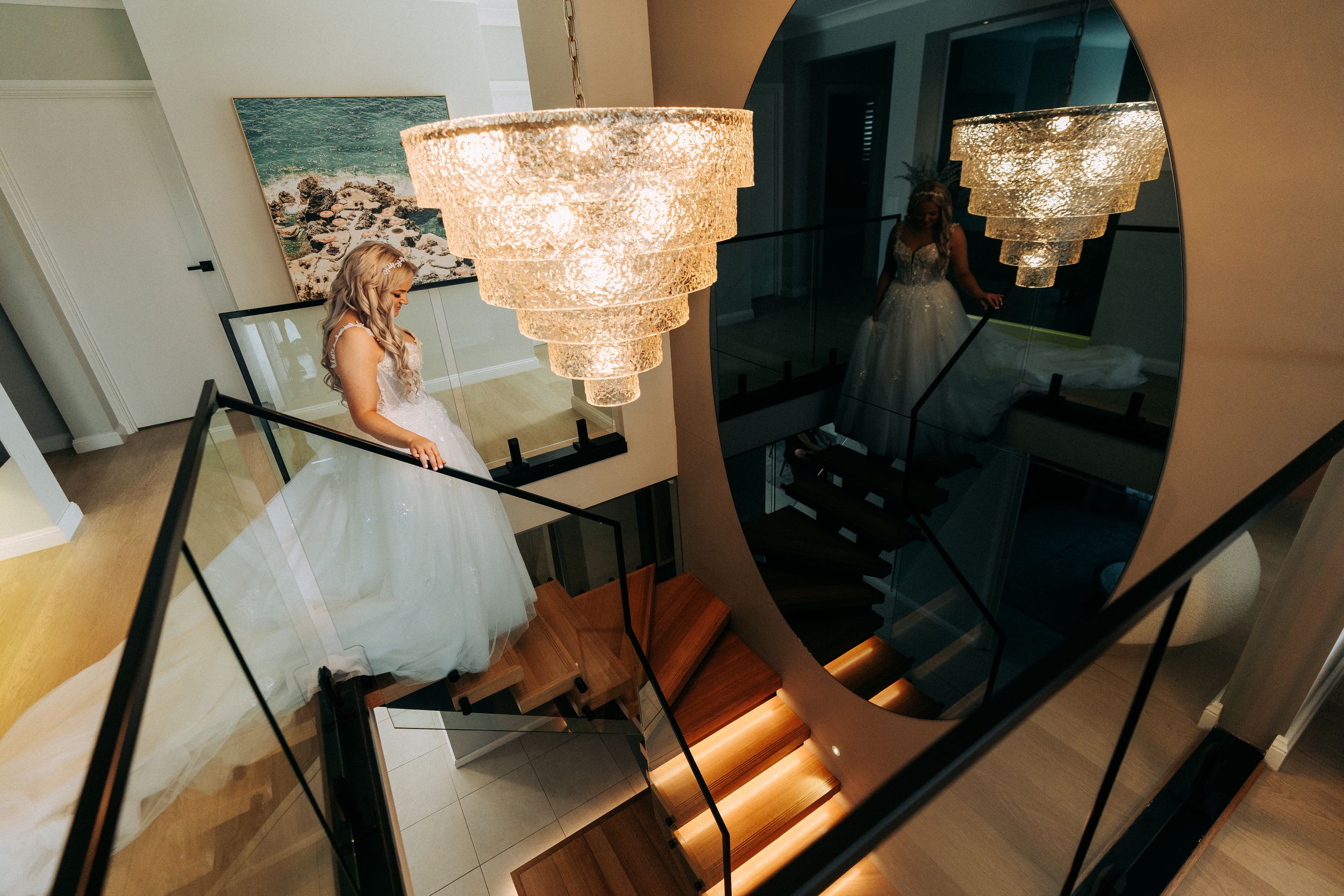 Wedding preparation room with crystal chandeliers and warm ambient lighting.