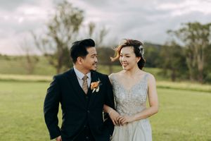 A couple shares a romantic moment together in a sunlit meadow.