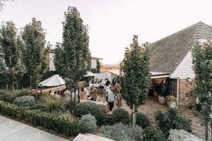 Wedding venue exterior with landscaped gardens and classic architecture.