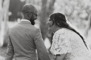Black and white wedding portrait capturing an intimate moment outdoors.