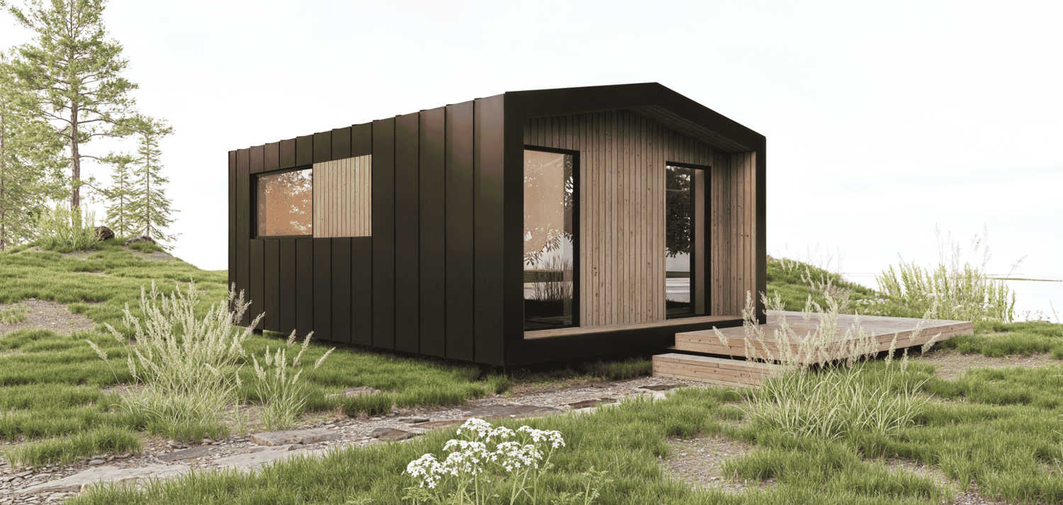 Modern modular house with dark exterior panels and floor-to-ceiling windows in desert environment.