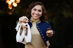 A fashion photo showing ballet shoes and accessories with bokeh lights in the background.