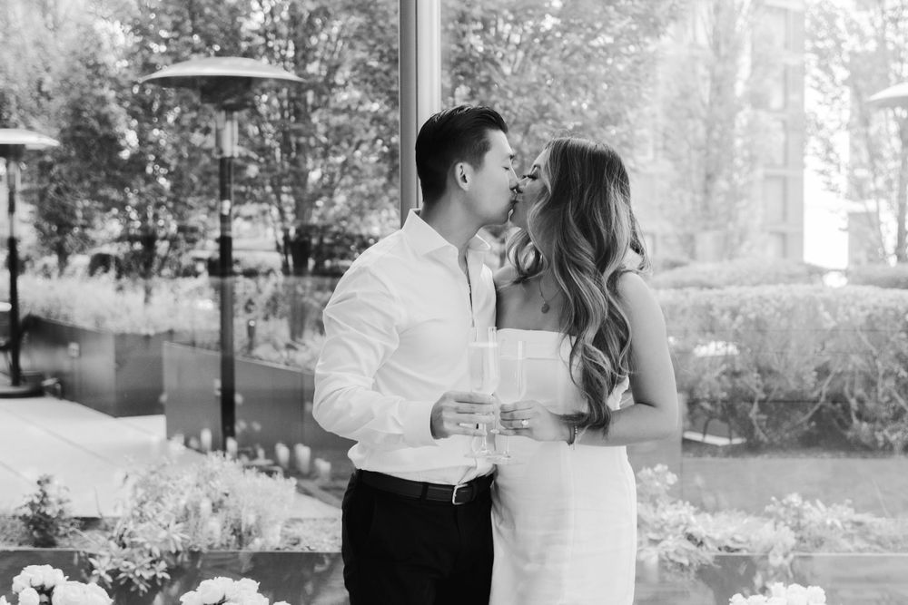 Couple sharing joyful moments together in an outdoor garden setting.