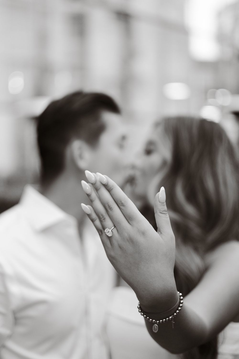 Close-up shots of hands showing off new engagement ring during celebration.