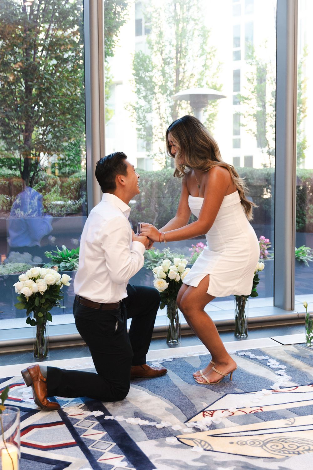 Sequence of a surprise proposal with white flowers in a sunlit room.