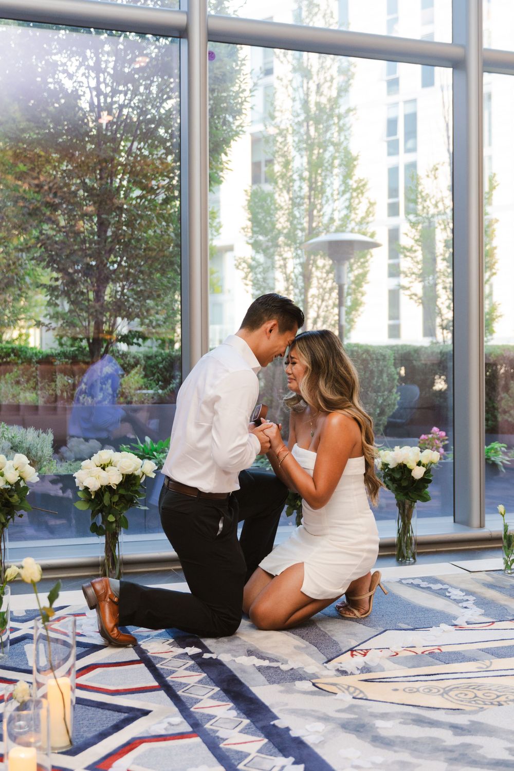 Proposal sequence showing emotional reactions in a bright, modern space with floor-to-ceiling windows.