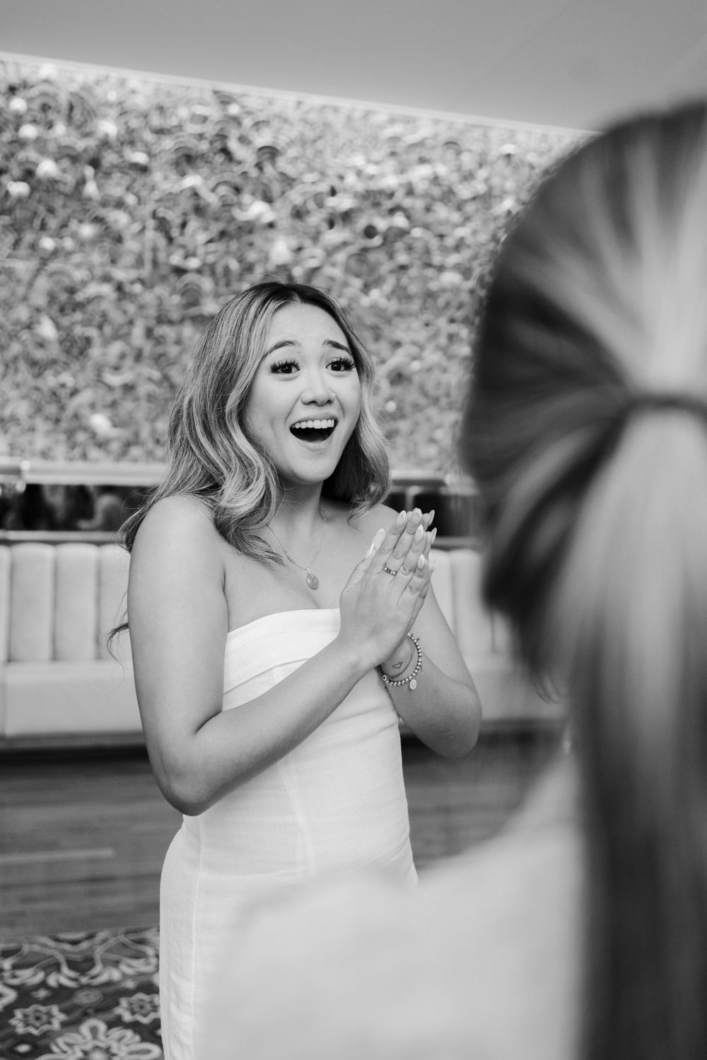 Black and white sequence showing emotional reactions during a surprise proposal moment.