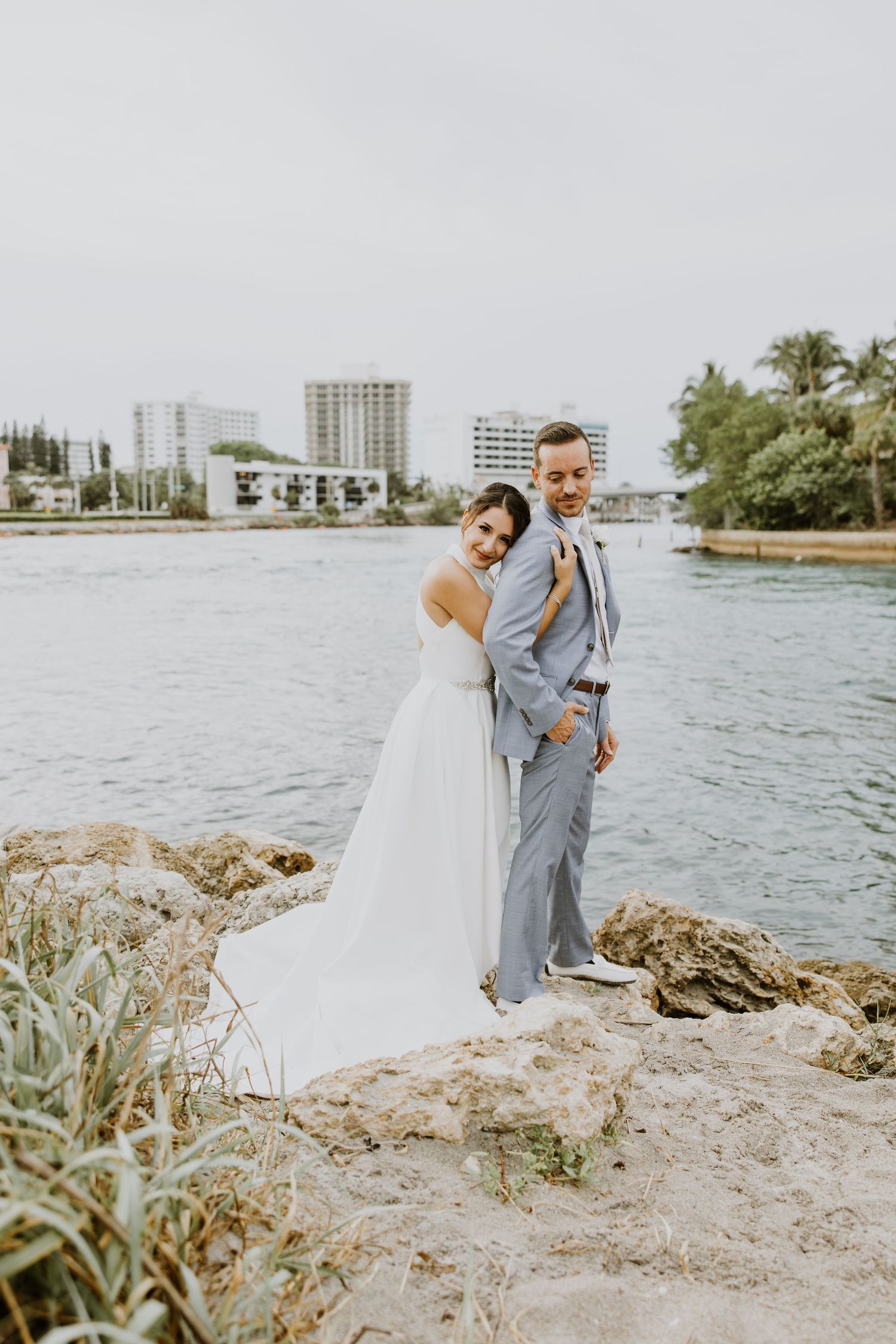 Intimate beach elopement in Boca Raton, Florida at South Inlet Park captured by Lindsay McDow Photography. Couple on the beach with family