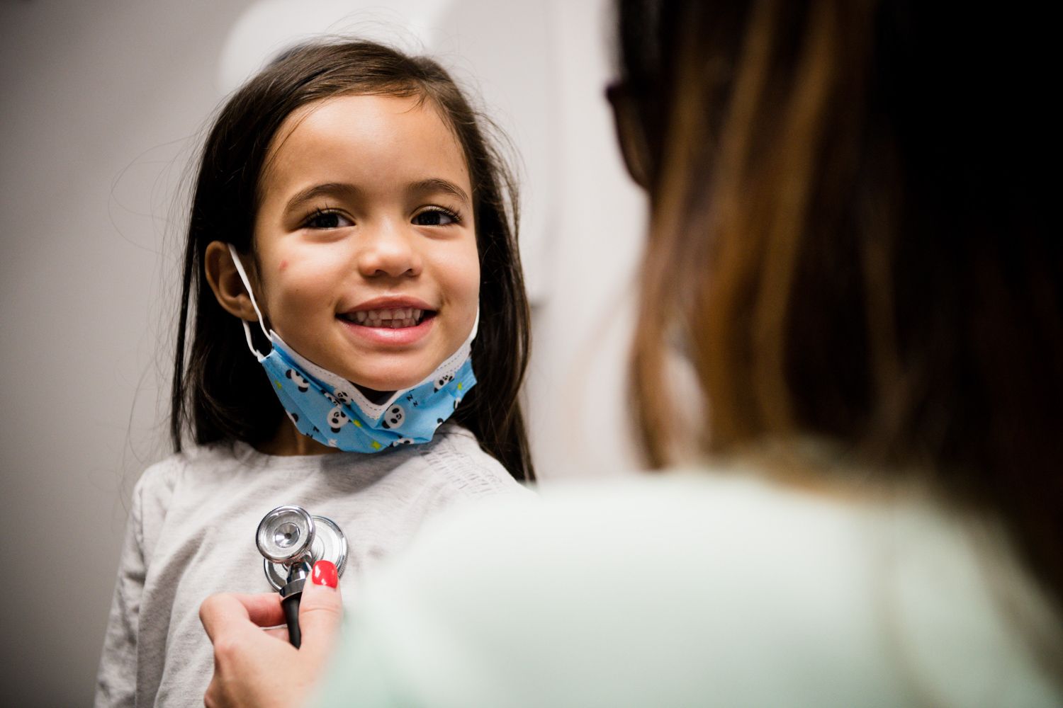 Paediatrician at Intercare consulting with a smiling child during a warm, friendly check-up.