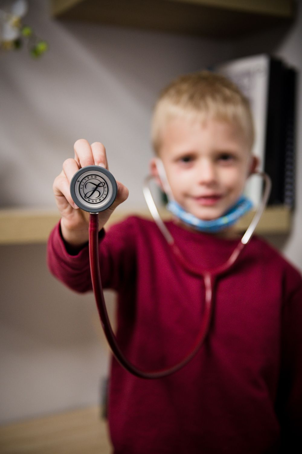Child playfully using a stethoscope during a fun and engaging doctor’s visit, highlighting a positive paediatric experience.