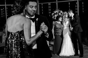 Dual black and white scene of couples sharing intimate dances at elegant wedding reception.