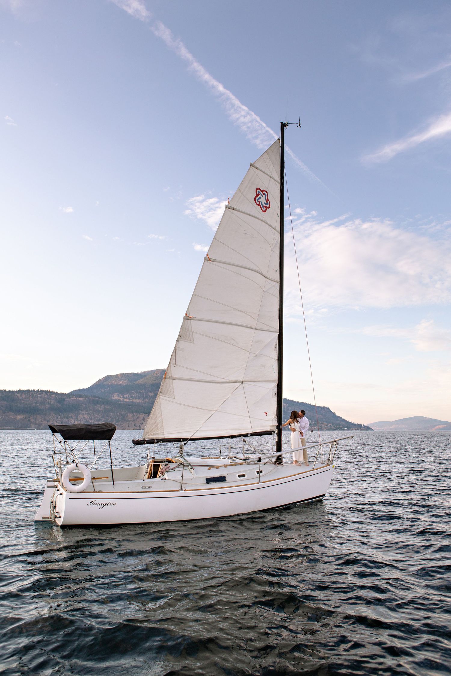 couple on sail boat on okanagan lake