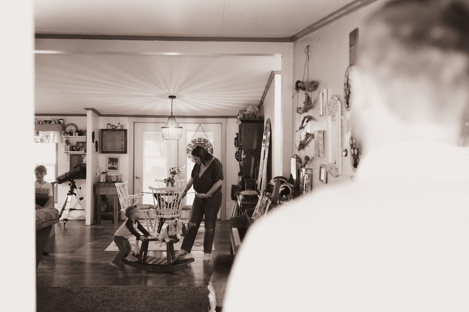 Husband looks in on wife during a lifestyle shoot at their home near Middletown, OH. Photographed by Vicci Photo of Dayton, OH