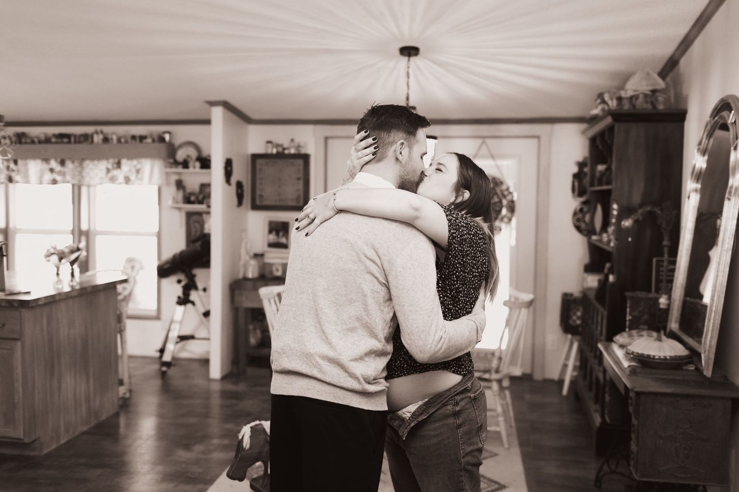 Couple embrace in a kiss during a lifestyle shoot at their home near Middletown, OH. Photographed by Vicci Photo of Dayton, OH