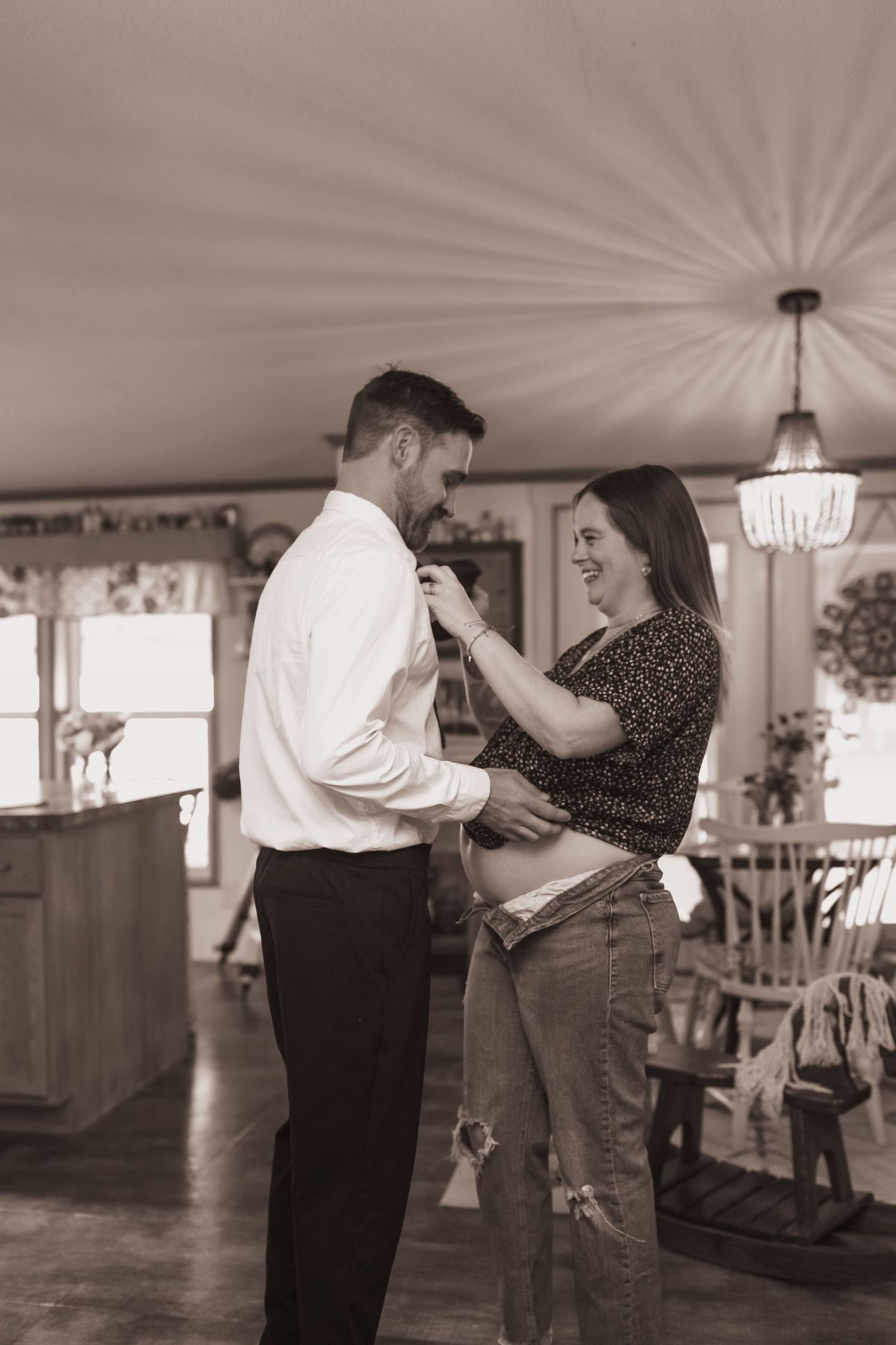 Couple embrace in their kitchen during a lifestyle shoot at their home near Middletown, OH. Photographed by Vicci Photo of Dayton, OH