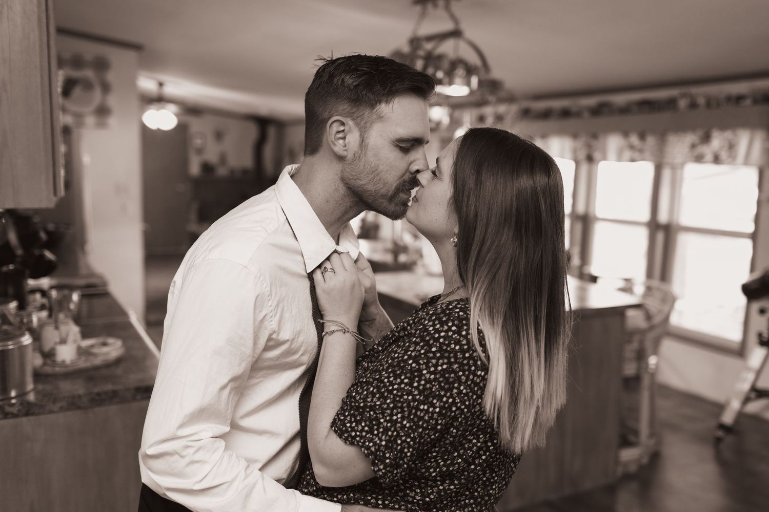Couple embrace in a kiss during a lifestyle shoot at their home near Middletown, OH. Photographed by Vicci Photo of Dayton, OH