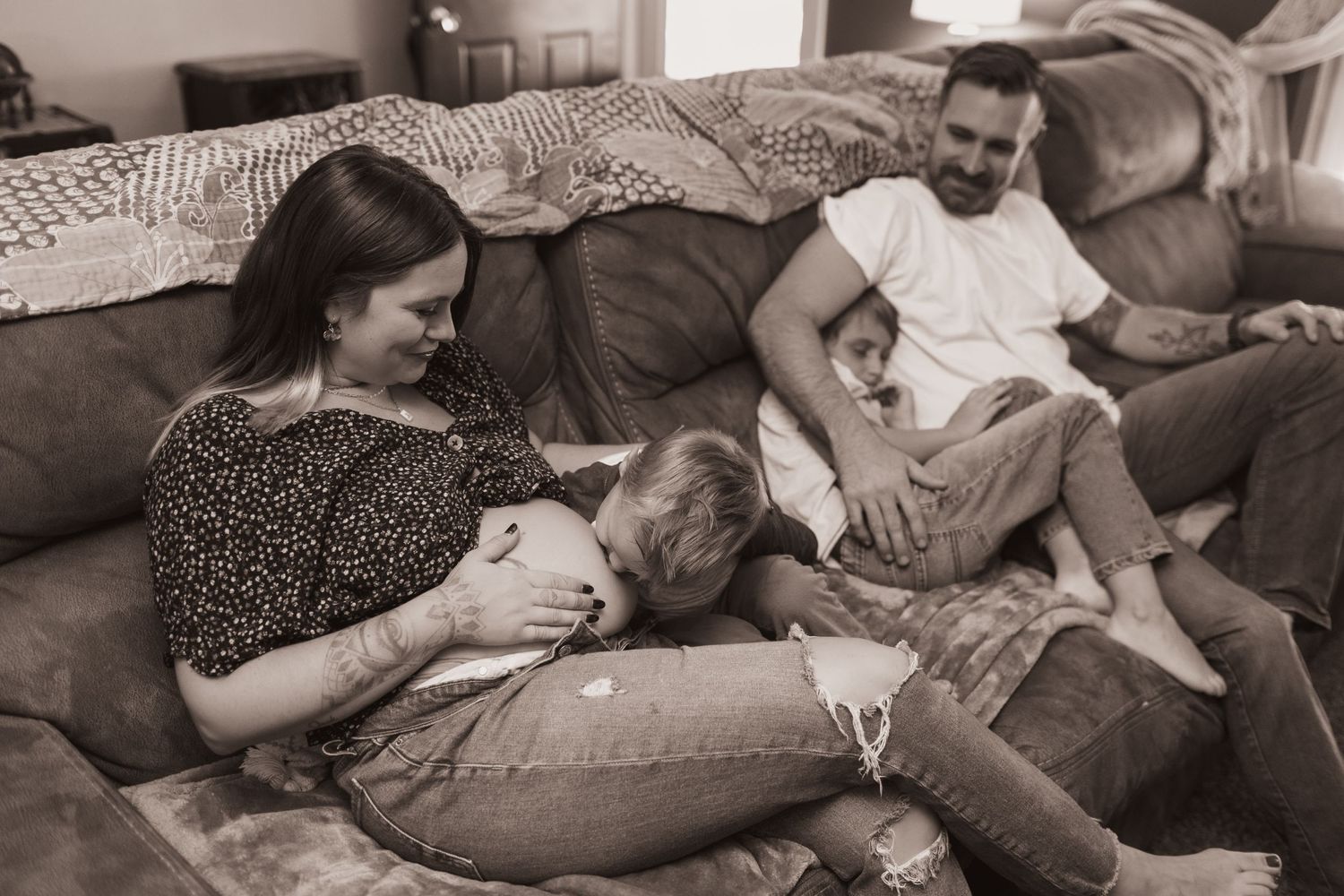 Family embraces on couch during a lifestyle shoot at their home near Middletown, OH. Photographed by Vicci Photo of Dayton, OH