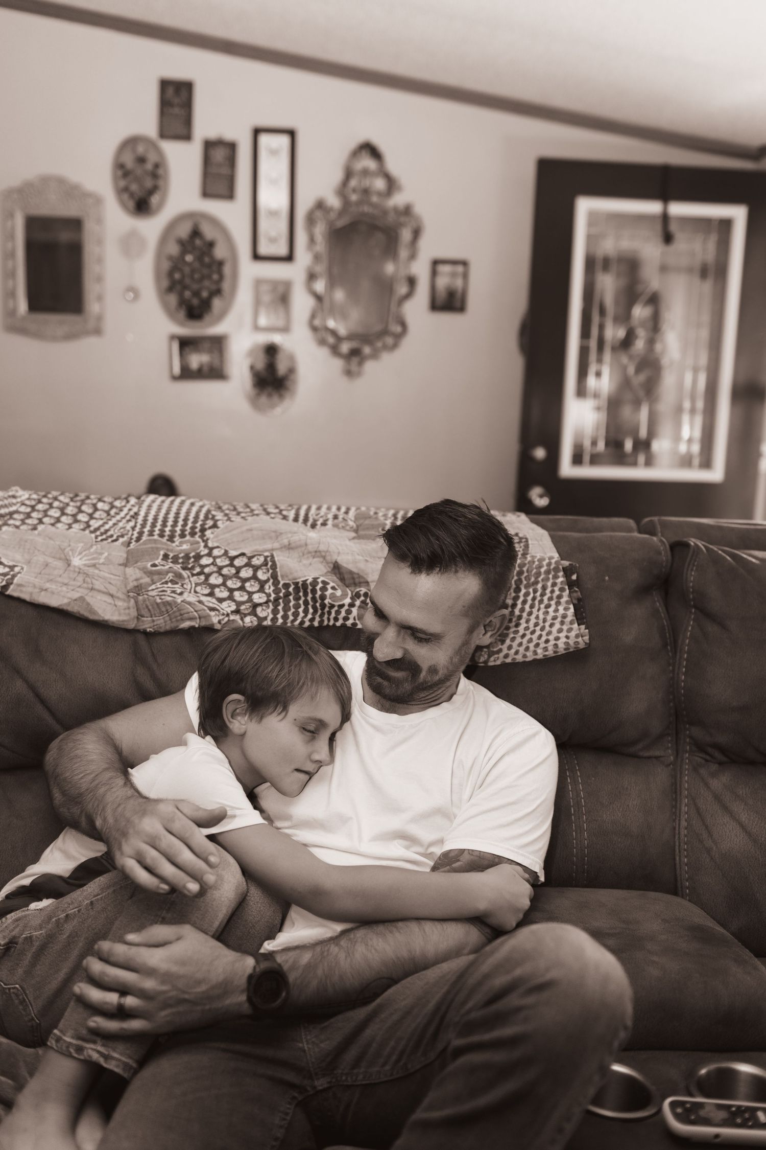 Father and son embrace during a lifestyle shoot at their home near Middletown, OH. Photographed by Vicci Photo of Dayton, OH