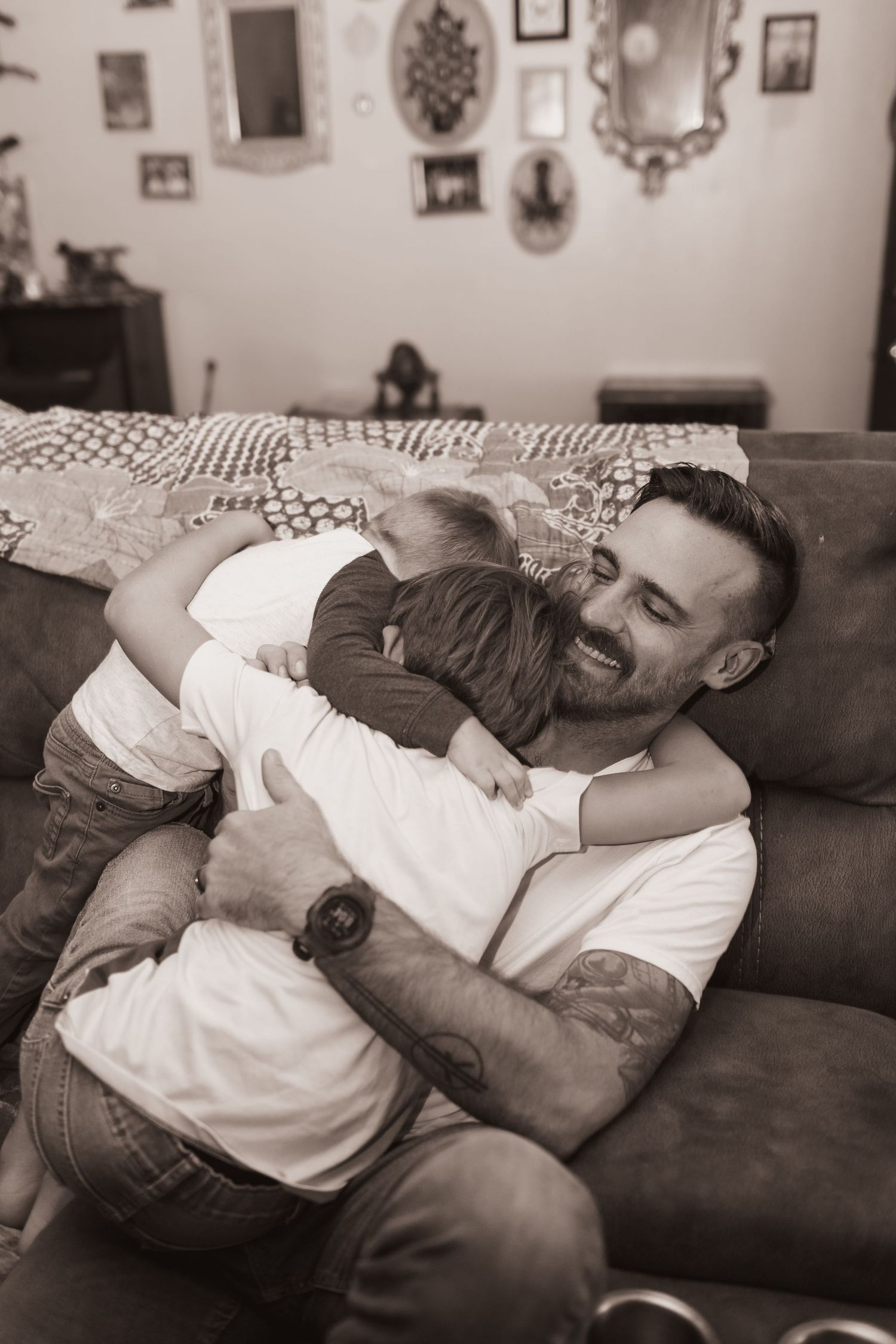 Father and sons embrace during a lifestyle shoot at their home near Middletown, OH. Photographed by Vicci Photo of Dayton, OH