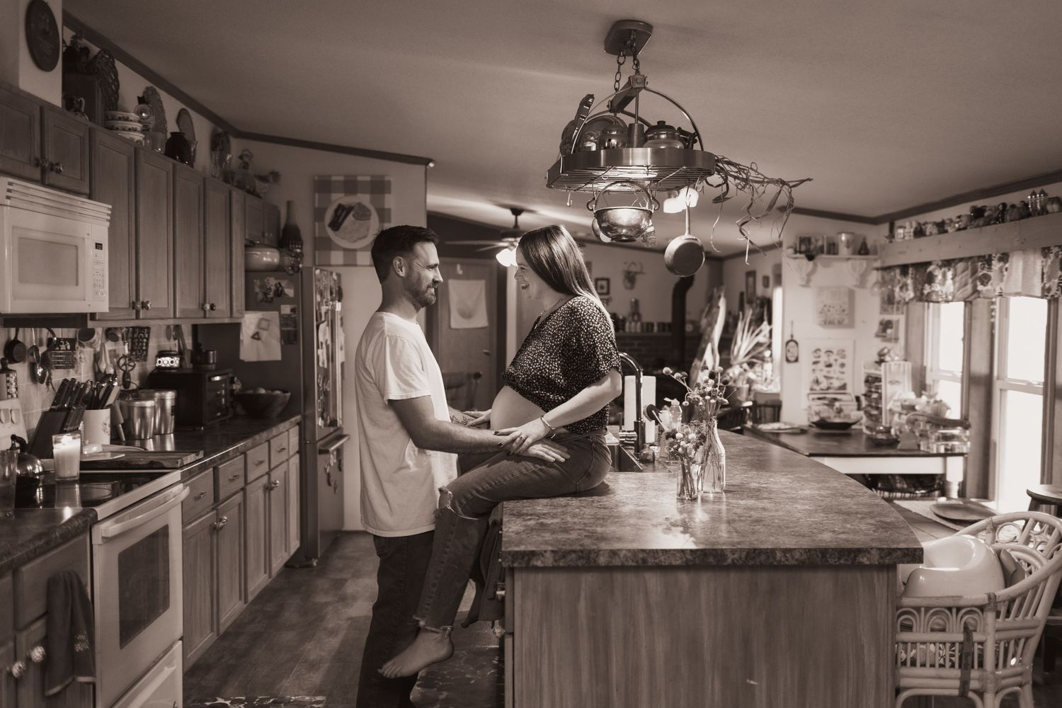Couple embraces in kitchen during a lifestyle shoot at their home near Middletown, OH. Photographed by Vicci Photo of Dayton, OH
