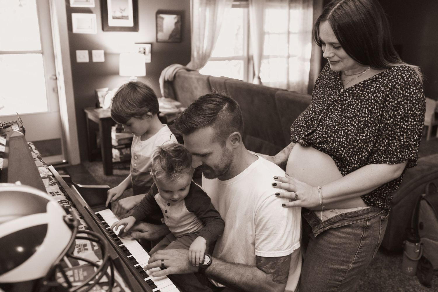 Family plays the piano during a lifestyle shoot at their home near Middletown, OH. Photographed by Vicci Photo of Dayton, OH