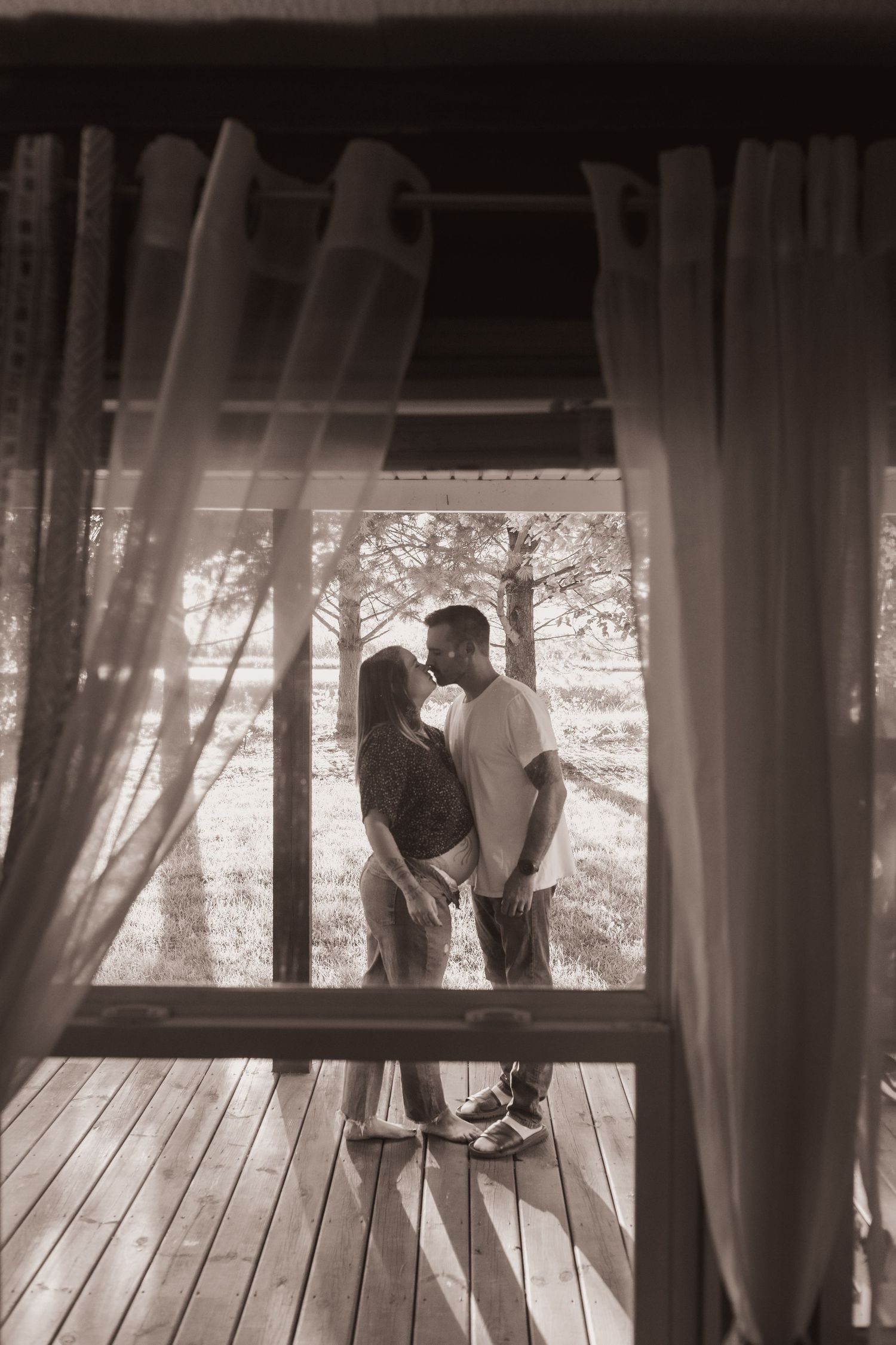 Family embraces on their porch during a lifestyle shoot at their home near Middletown, OH. Photographed by Vicci Photo of Dayton, OH