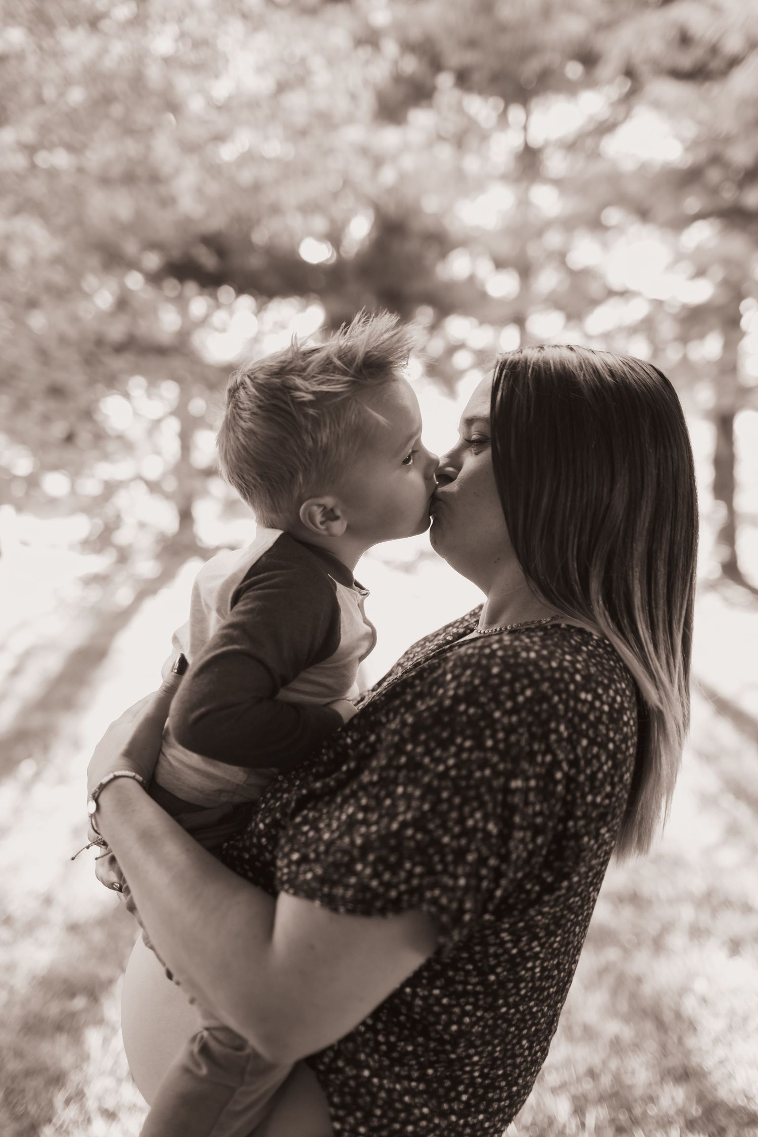 Mom and son embrace in their front yard during a lifestyle shoot at their home near Middletown OH. Photographed by Vicci Photo of Dayton OH