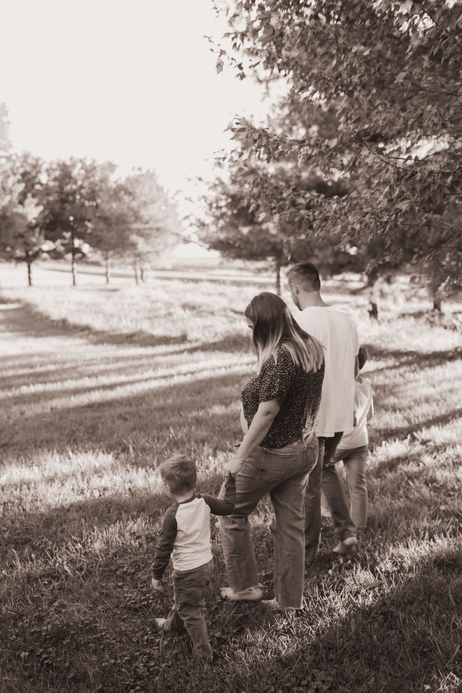 Family walking in their front yard during a lifestyle shoot at their home near Middletown, OH. Photographed by Vicci Photo of Dayton, OH
