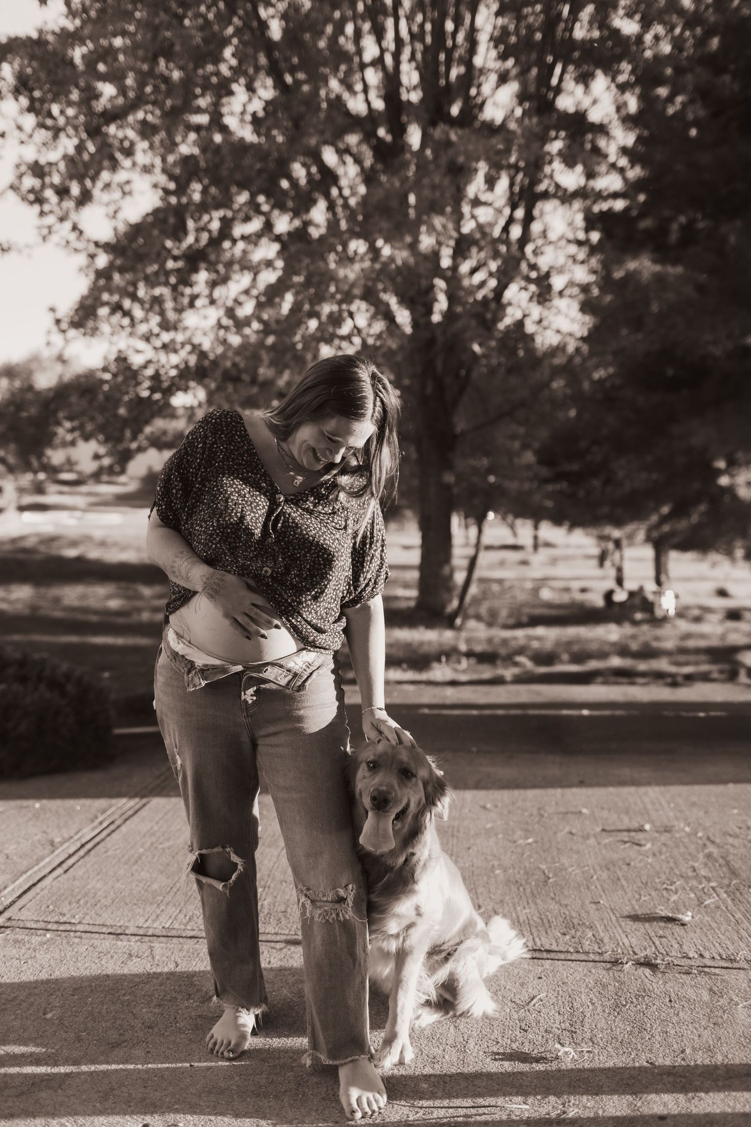 Mom posing with her pregnant belly and petting her dog for pics at their home near Middletown, OH. Photographed by Vicci Photo of Dayton, OH