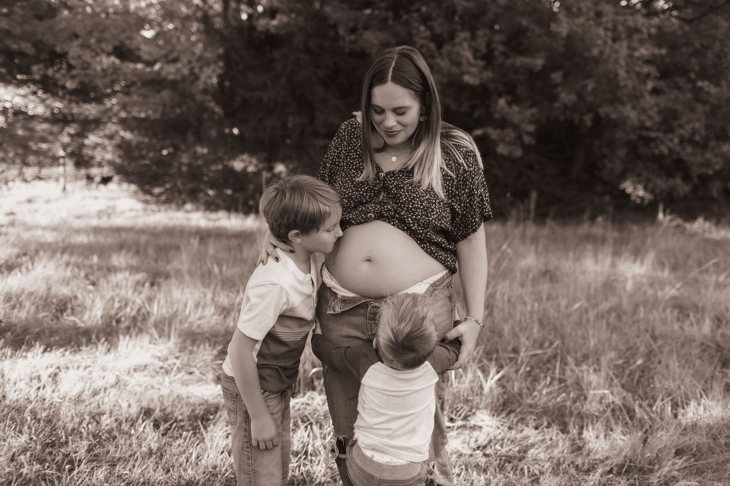 Mom and 2 boys, posing with mom's belly for maternity pics at their home near Middletown, OH - Photographed by Vicci Photo of Dayton, OH