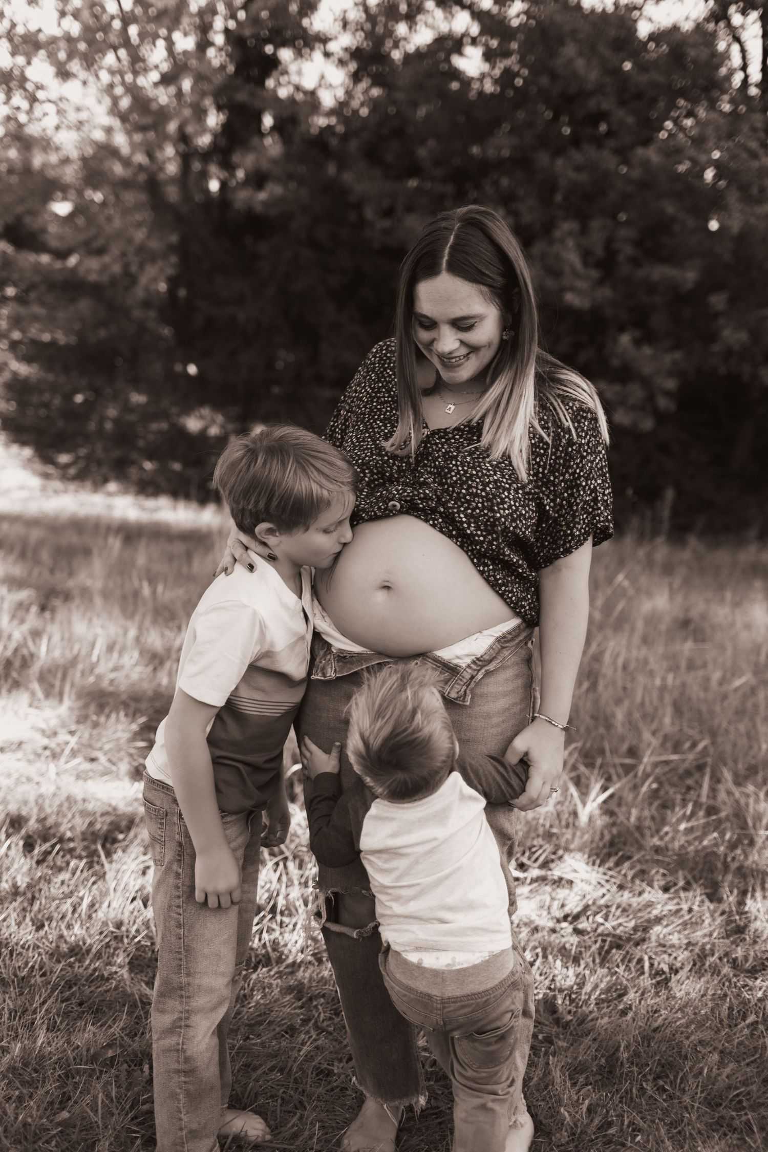 Mom and 2 boys, posing with mom's belly for maternity pics at their home near Middletown, OH - Photographed by Vicci Photo of Dayton, OH