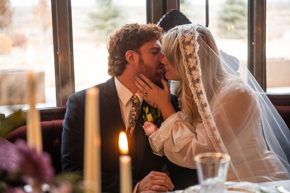 Intimate candlelit wedding moment captured during indoor reception.