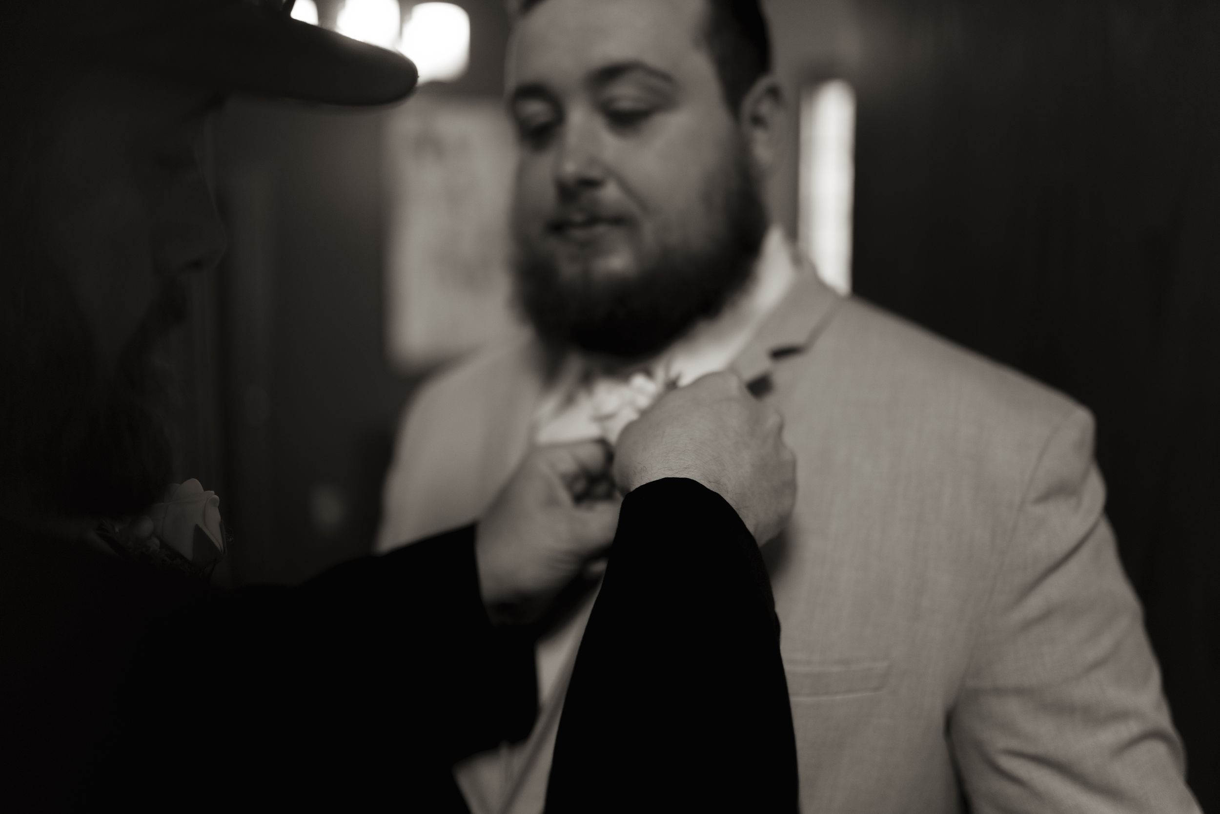 Black and white images capture intimate dance moments at an indoor celebration.