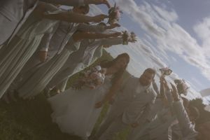 Artistic panoramic shot of wedding celebration in a scenic outdoor setting.