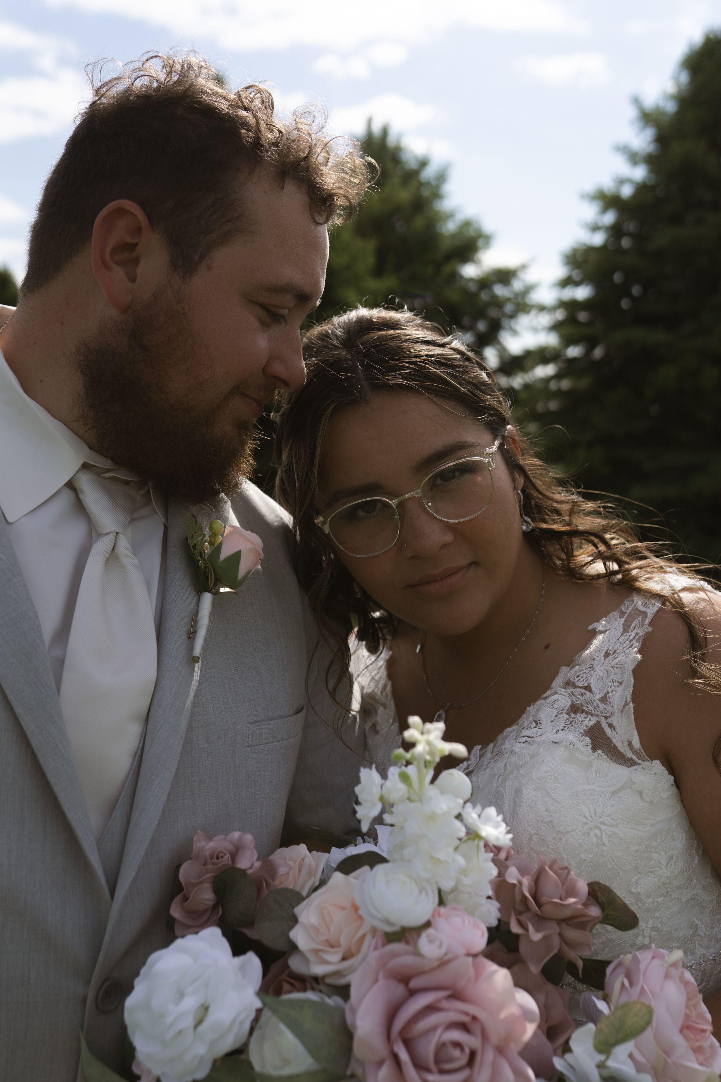 Intimate close-up wedding photos with pink and white rose bouquet details.
