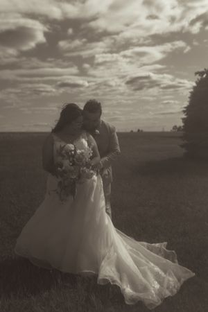 Black and white artistic shots of flowing wedding dress movement in open field.